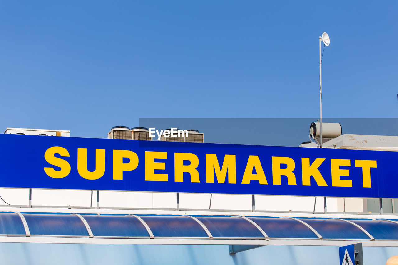 LOW ANGLE VIEW OF ILLUMINATED STREET LIGHT AGAINST CLEAR BLUE SKY