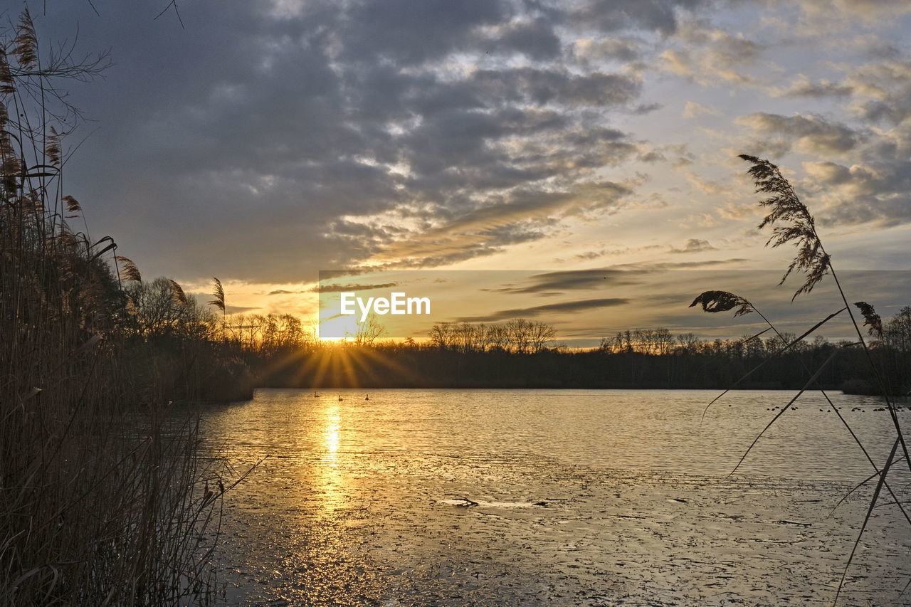 SCENIC VIEW OF LAKE DURING SUNSET