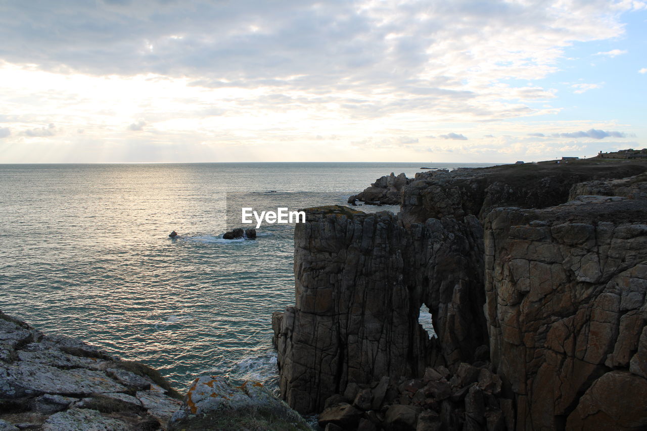rock formations by sea against sky