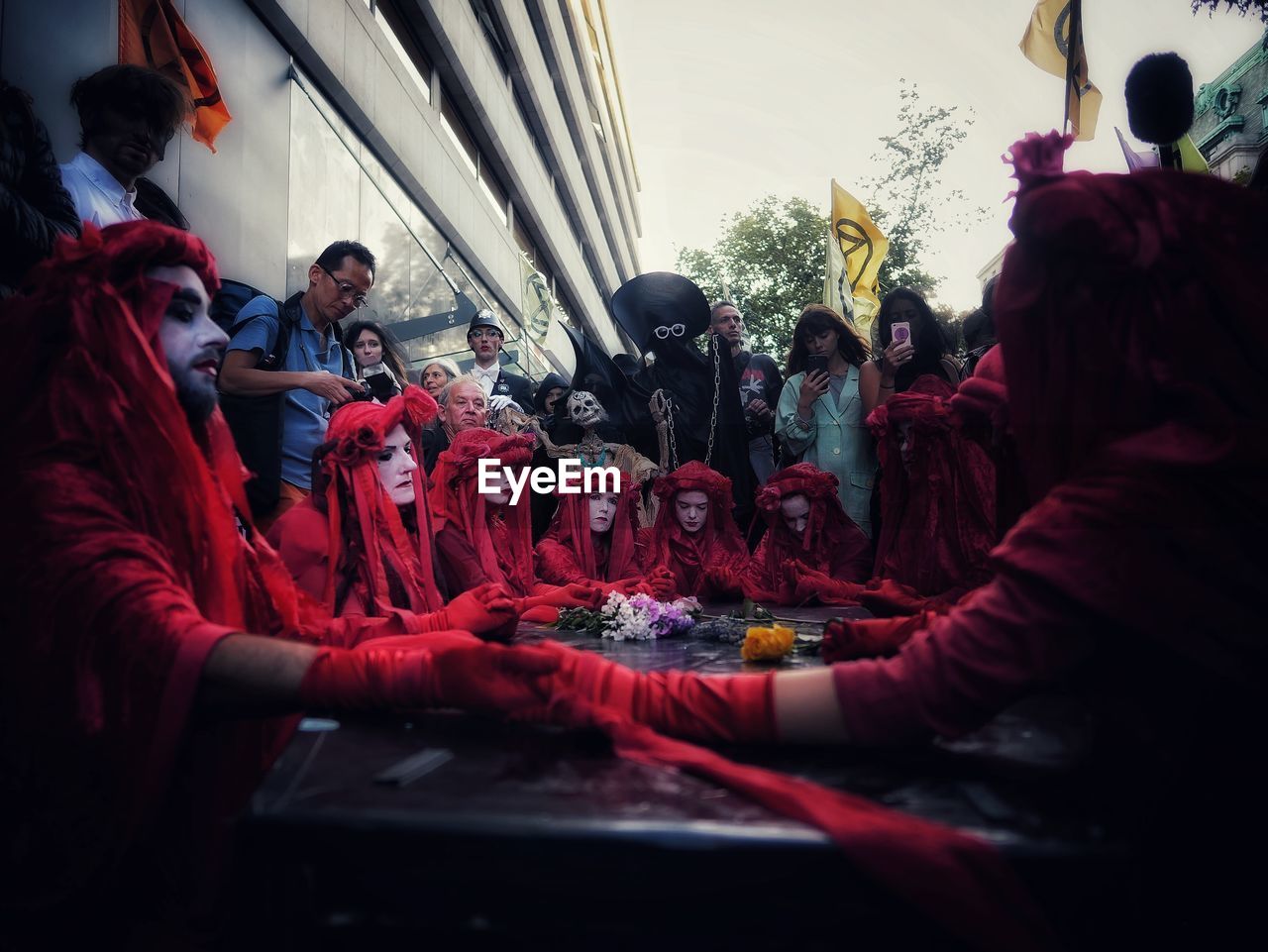 GROUP OF PEOPLE SITTING IN TRADITIONAL TEMPLE