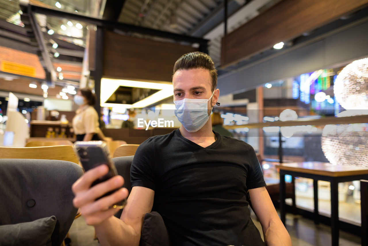 Portrait of young man using mobile phone