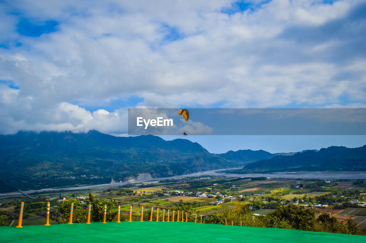 HOT AIR BALLOONS FLYING OVER FIELD