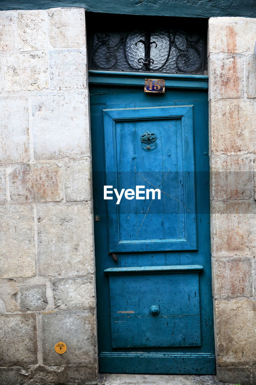 CLOSED BLUE DOOR OF BUILDING