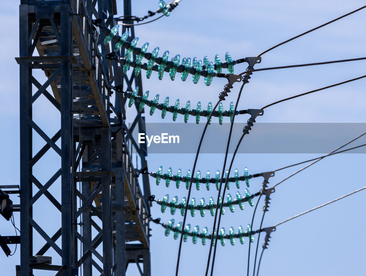 electricity, technology, overhead power line, sky, transmission tower, tower, electricity pylon, communication, cable, electrical supply, power generation, no people, architecture, nature, power supply, mast, outdoor structure, warning sign, built structure, sign, outdoors, line, day, complexity, metal, low angle view, blue, power line