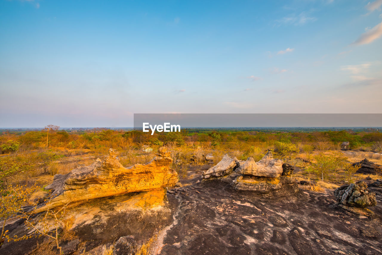 Scenic view of land against sky during sunset