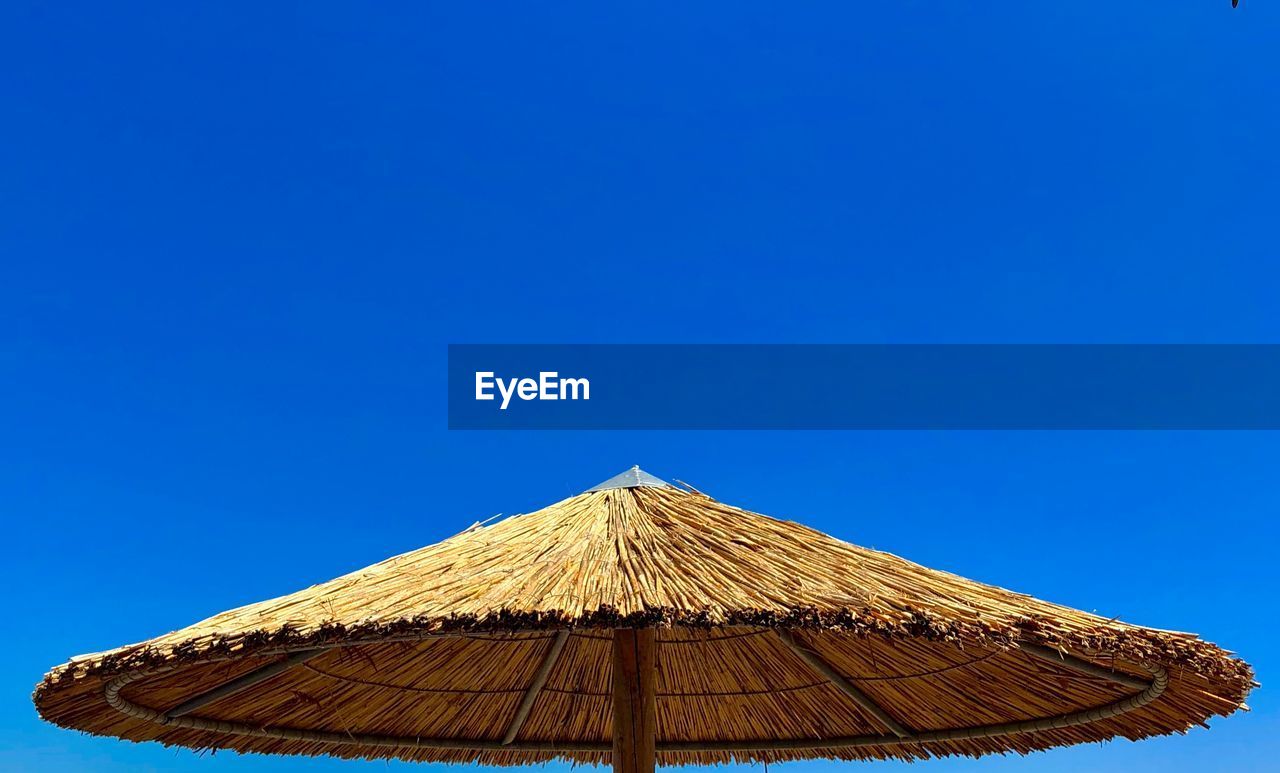 LOW ANGLE VIEW OF ROOF AGAINST BLUE SKY