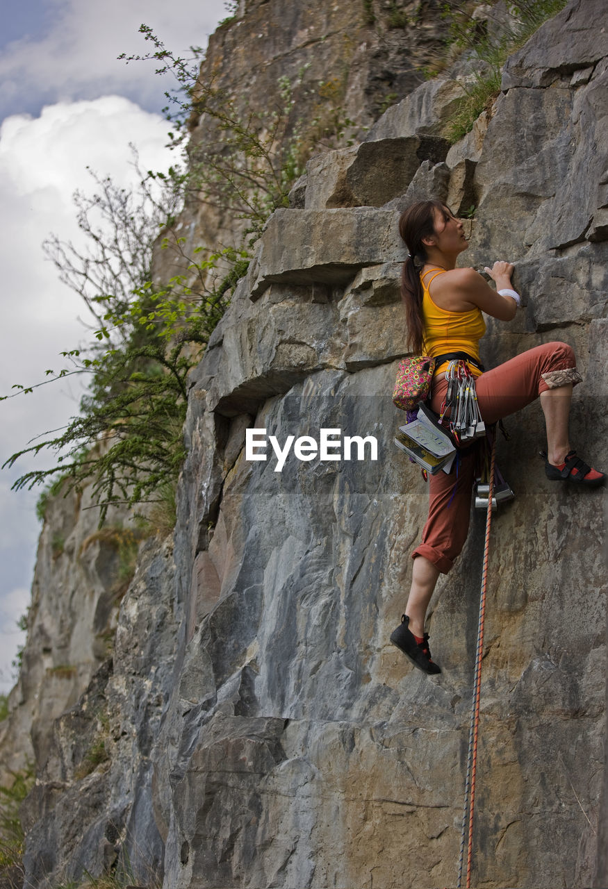 Female climber on a difficult climb in the wye valley / south wales