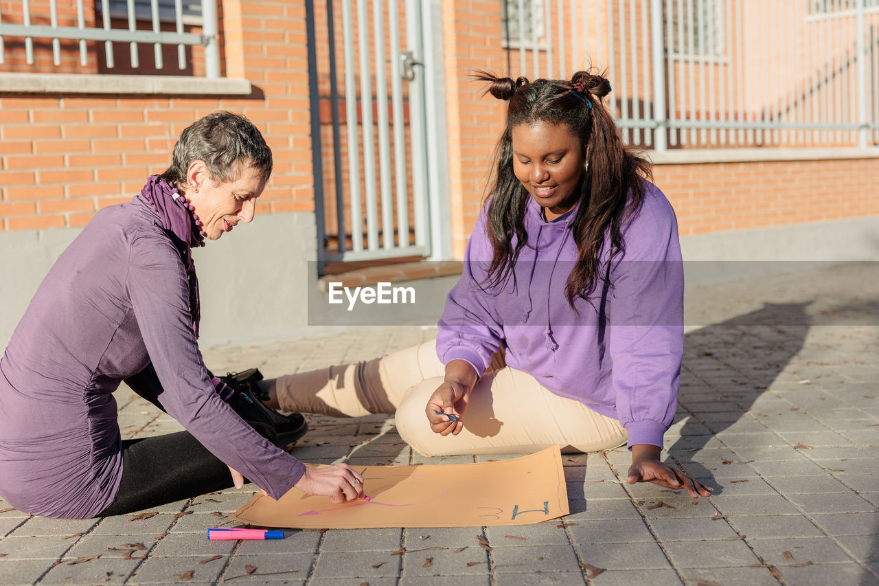 Female friends doing work during protest