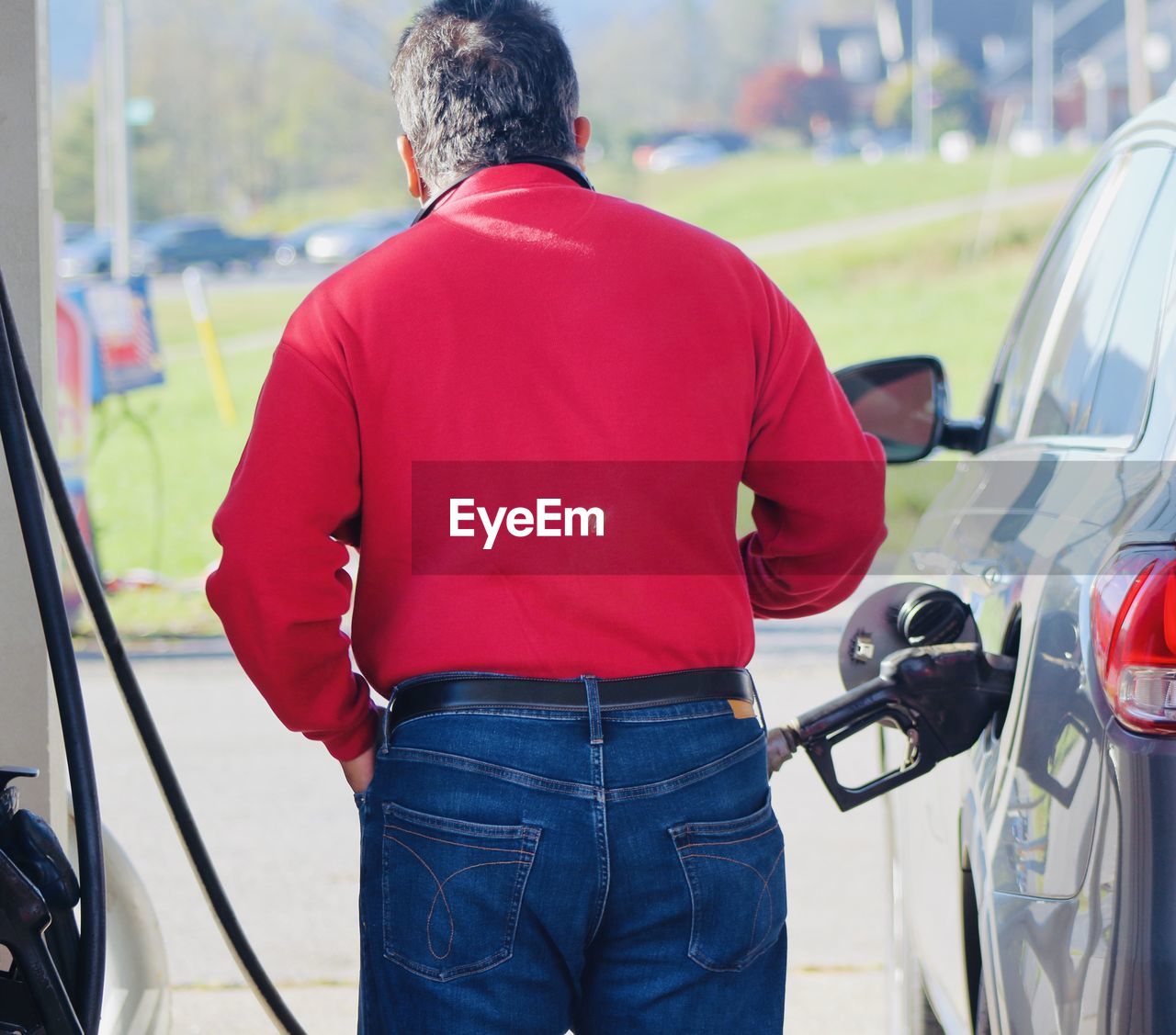 rear view of man standing by motorcycle