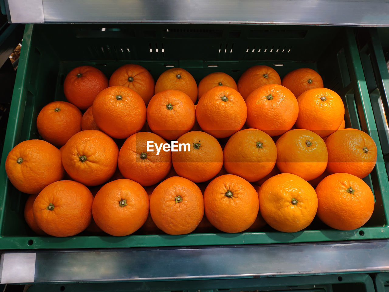 Oranges on basket in supermarket.