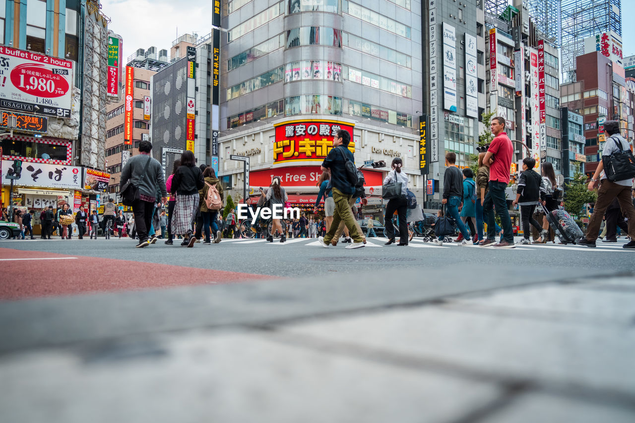 Surface level of people walking on city street