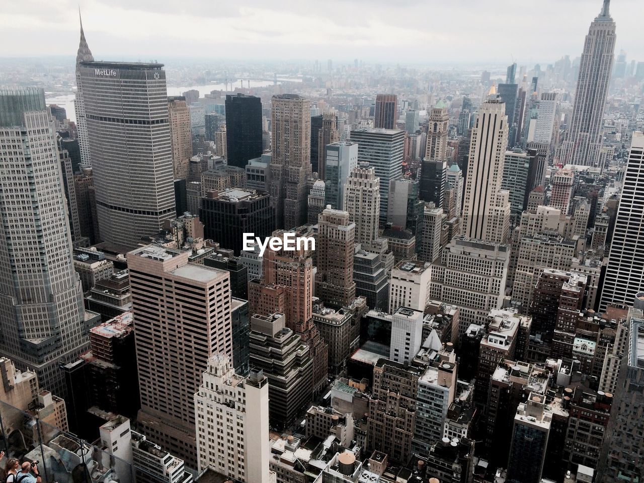 Aerial view of buildings in city against sky