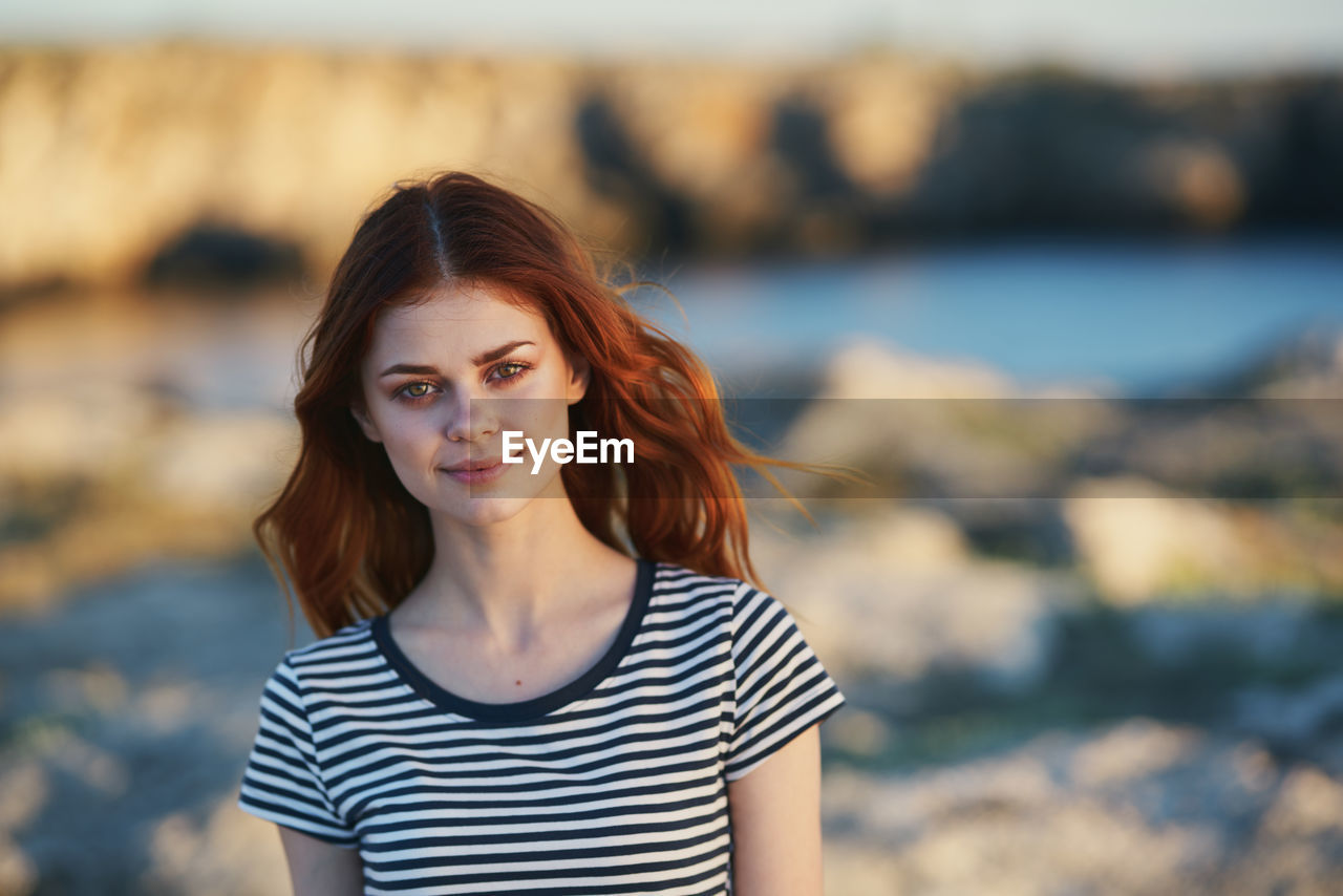 Portrait of smiling young woman standing outdoors