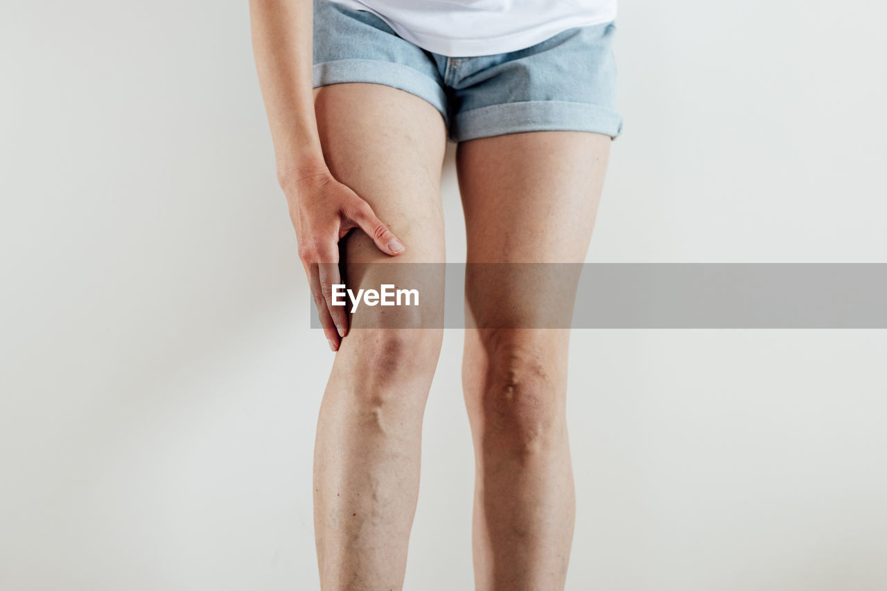 low section of woman standing on white background