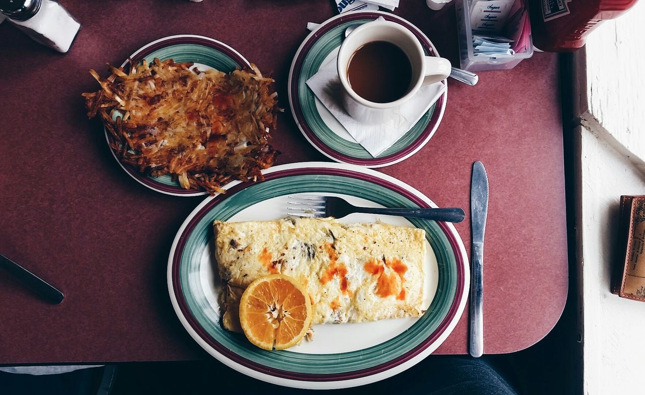 Directly above shot of egg omelet with coffee cup served on table