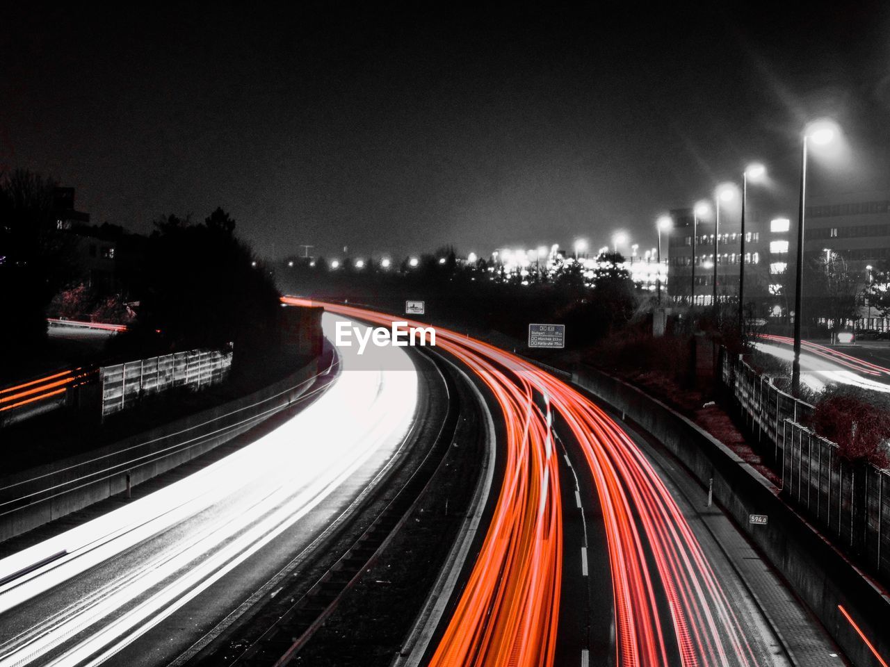 High angle view of light trails on highway at night