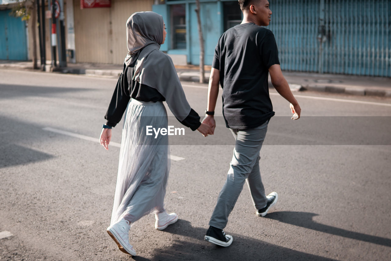 Rear view of people walking on street