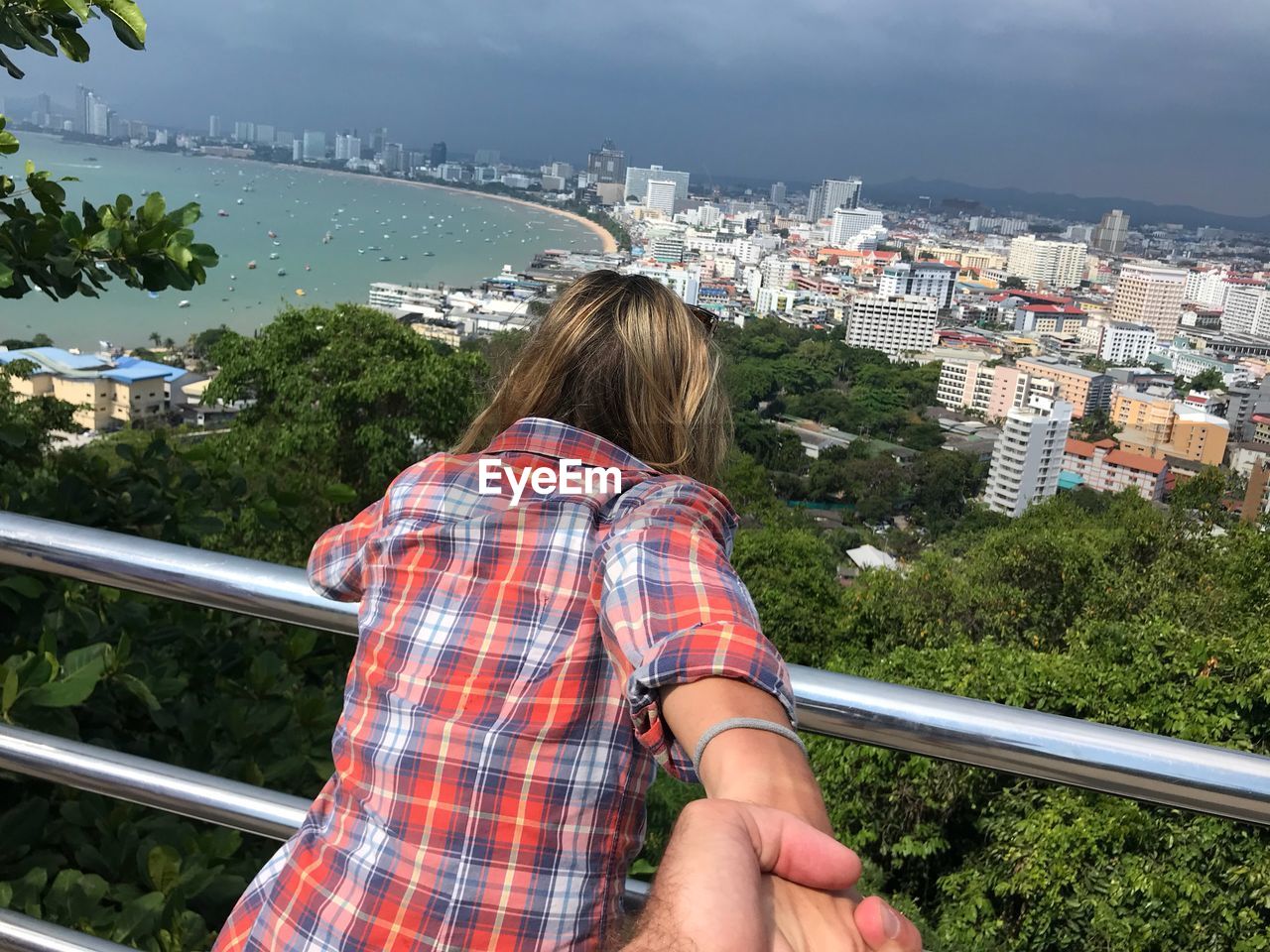 Rear view of woman looking at cityscape