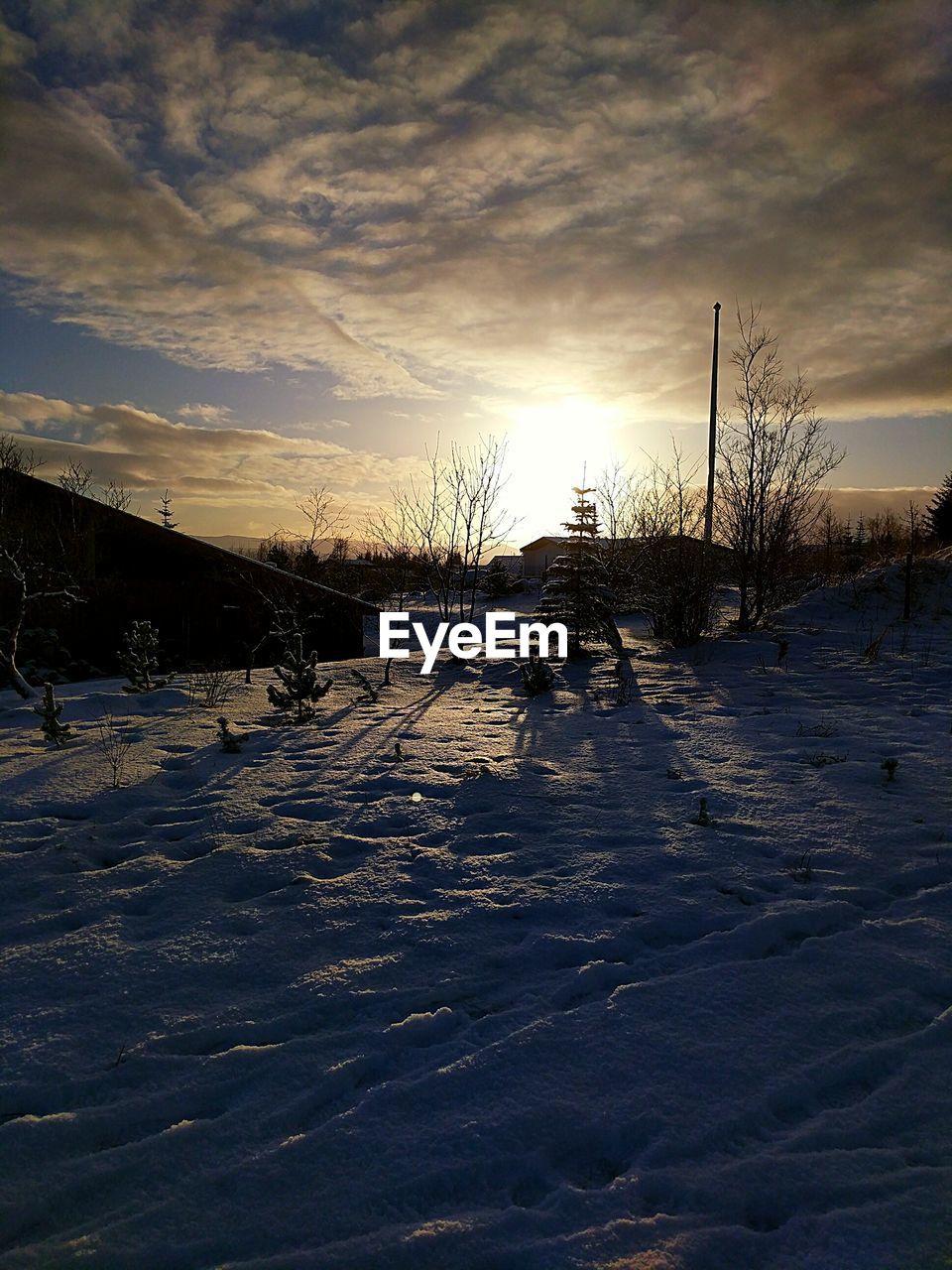 FROZEN FIELD AGAINST SKY DURING WINTER