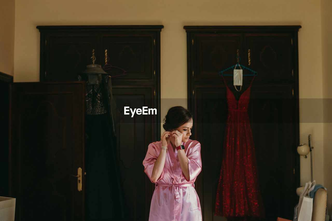 Bride getting dressed for wedding