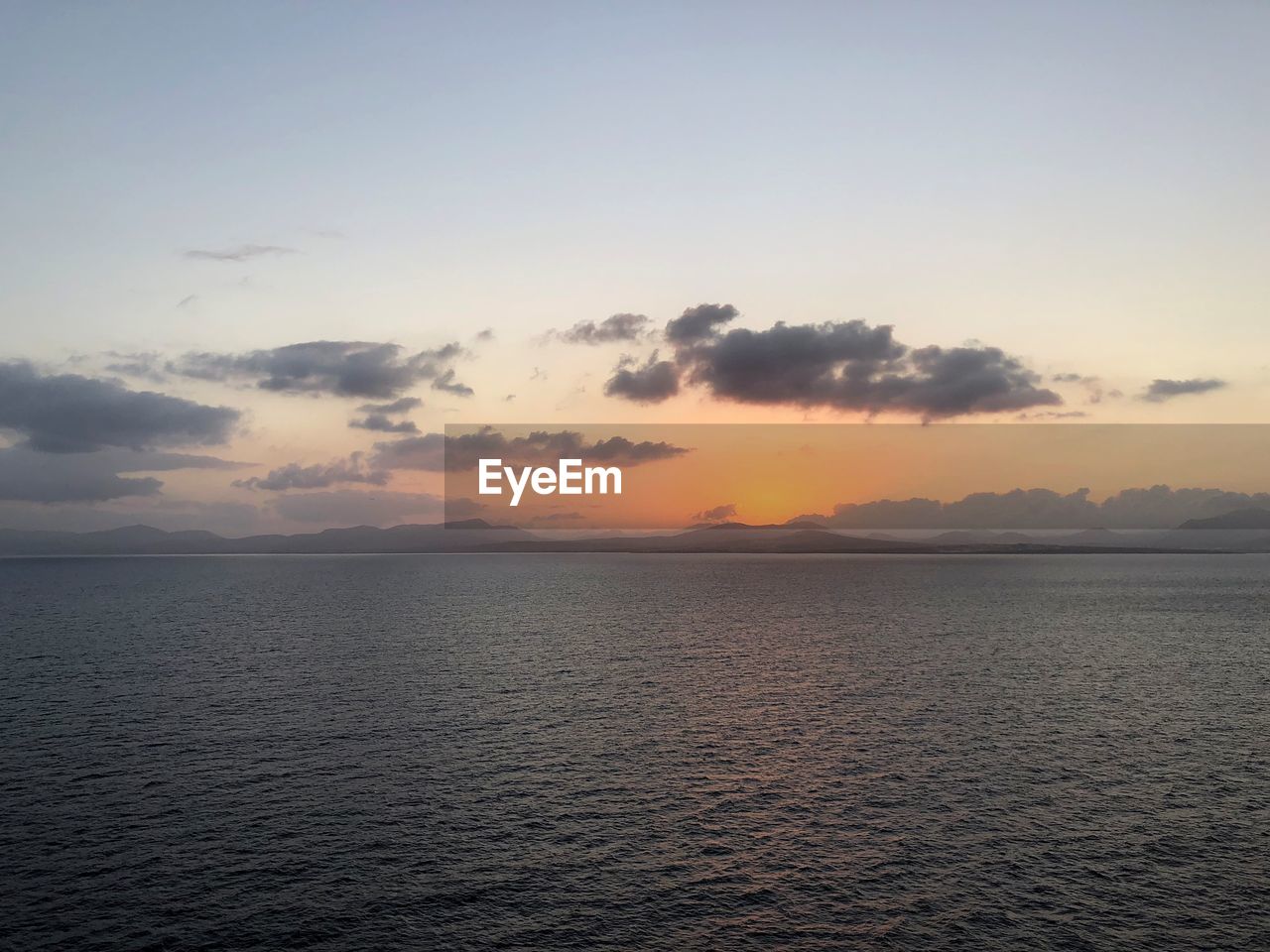 SCENIC VIEW OF SEA DURING SUNSET