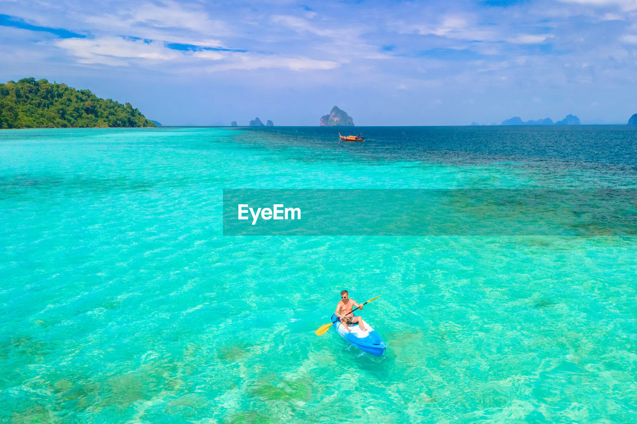 man swimming in sea