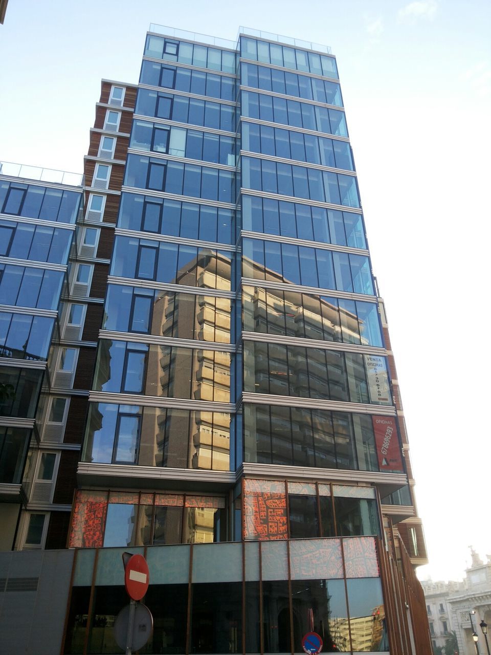 Low angle view of glass buildings against sky