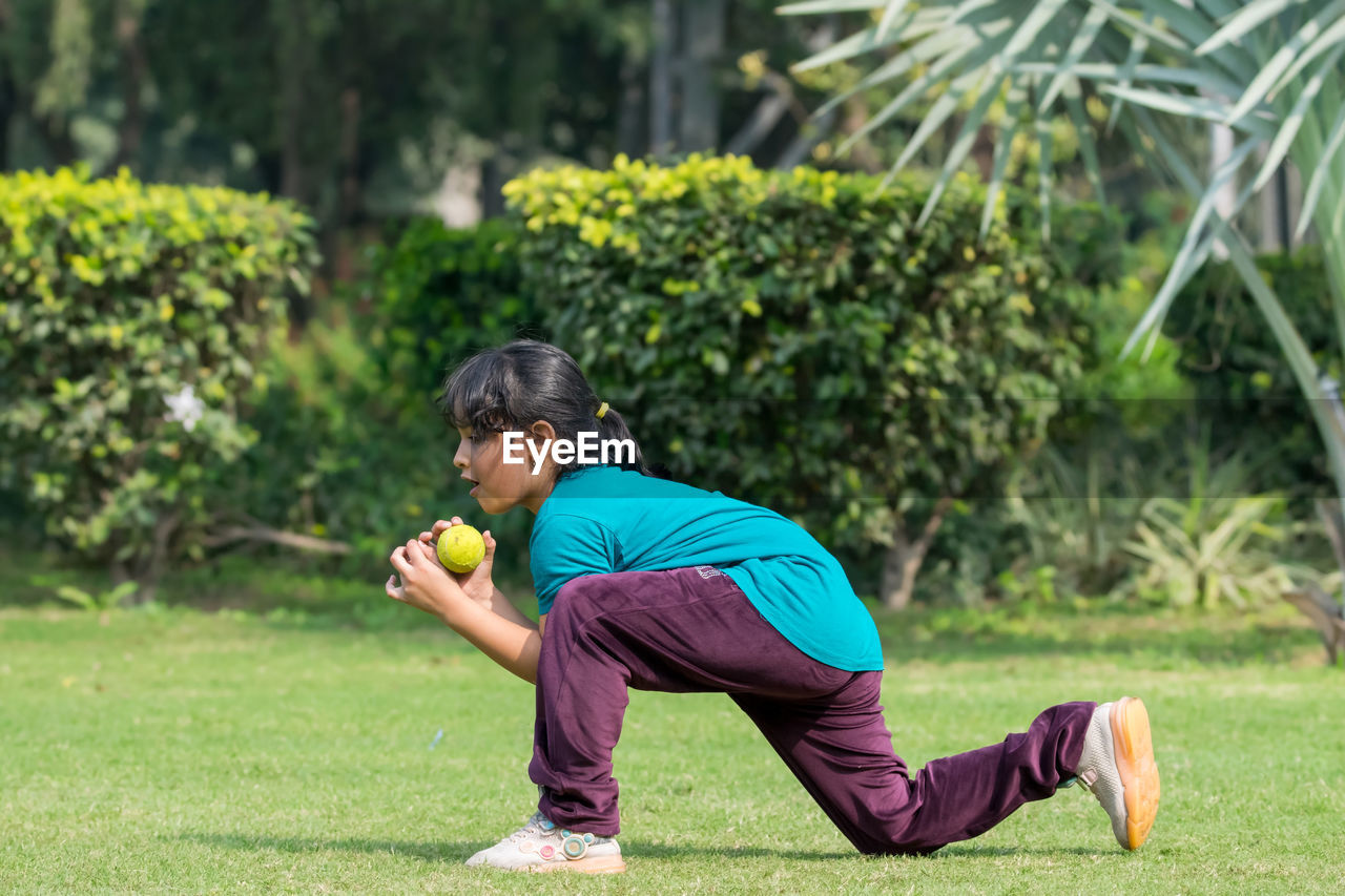one person, sports, lifestyles, men, plant, adult, full length, grass, exercising, leisure activity, nature, lawn, casual clothing, wellbeing, relaxation, green, day, activity, outdoors, sports clothing, childhood, clothing, side view, athlete, person, child, young adult, sports training