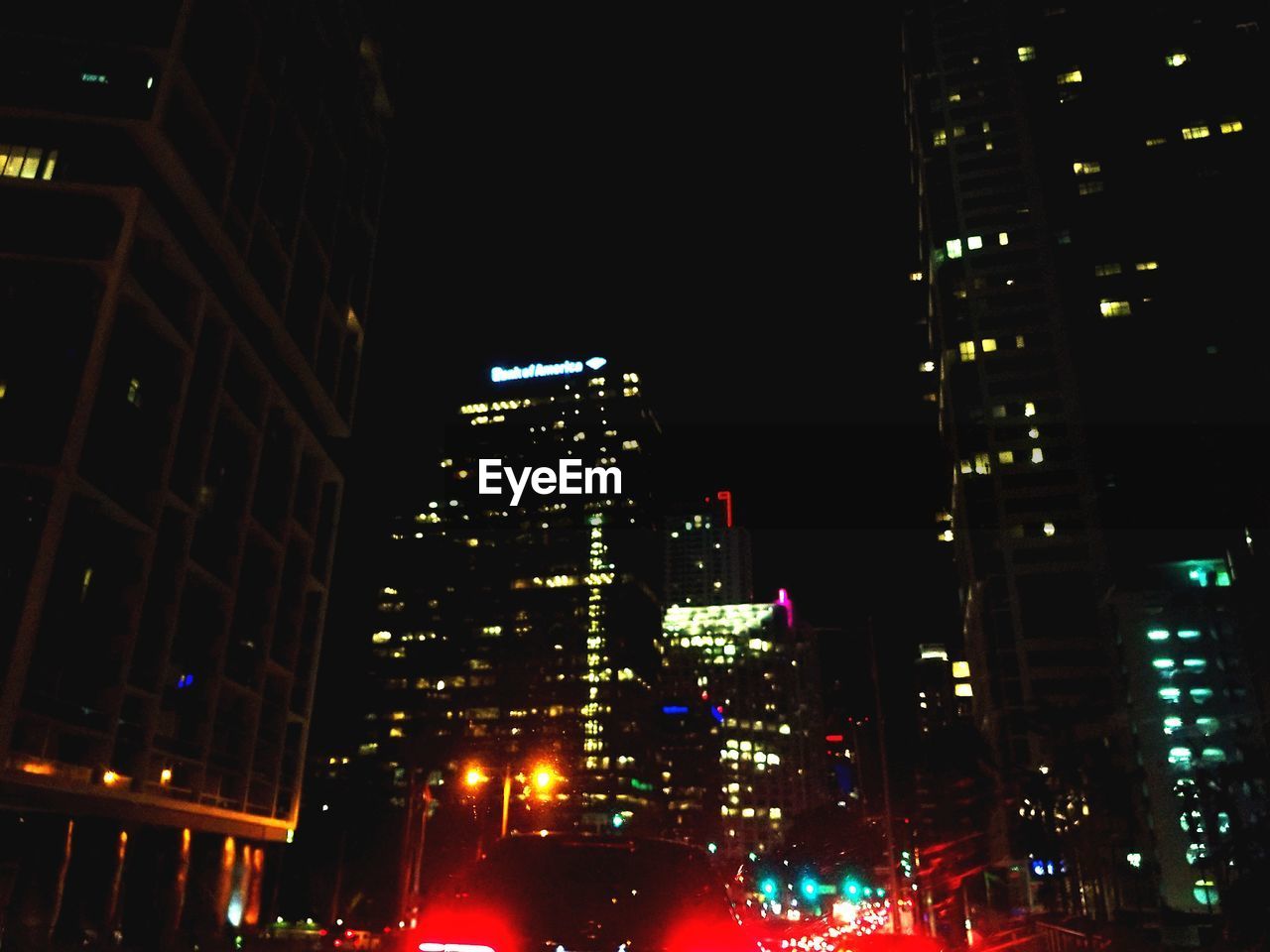 VIEW OF ILLUMINATED CITY AT NIGHT