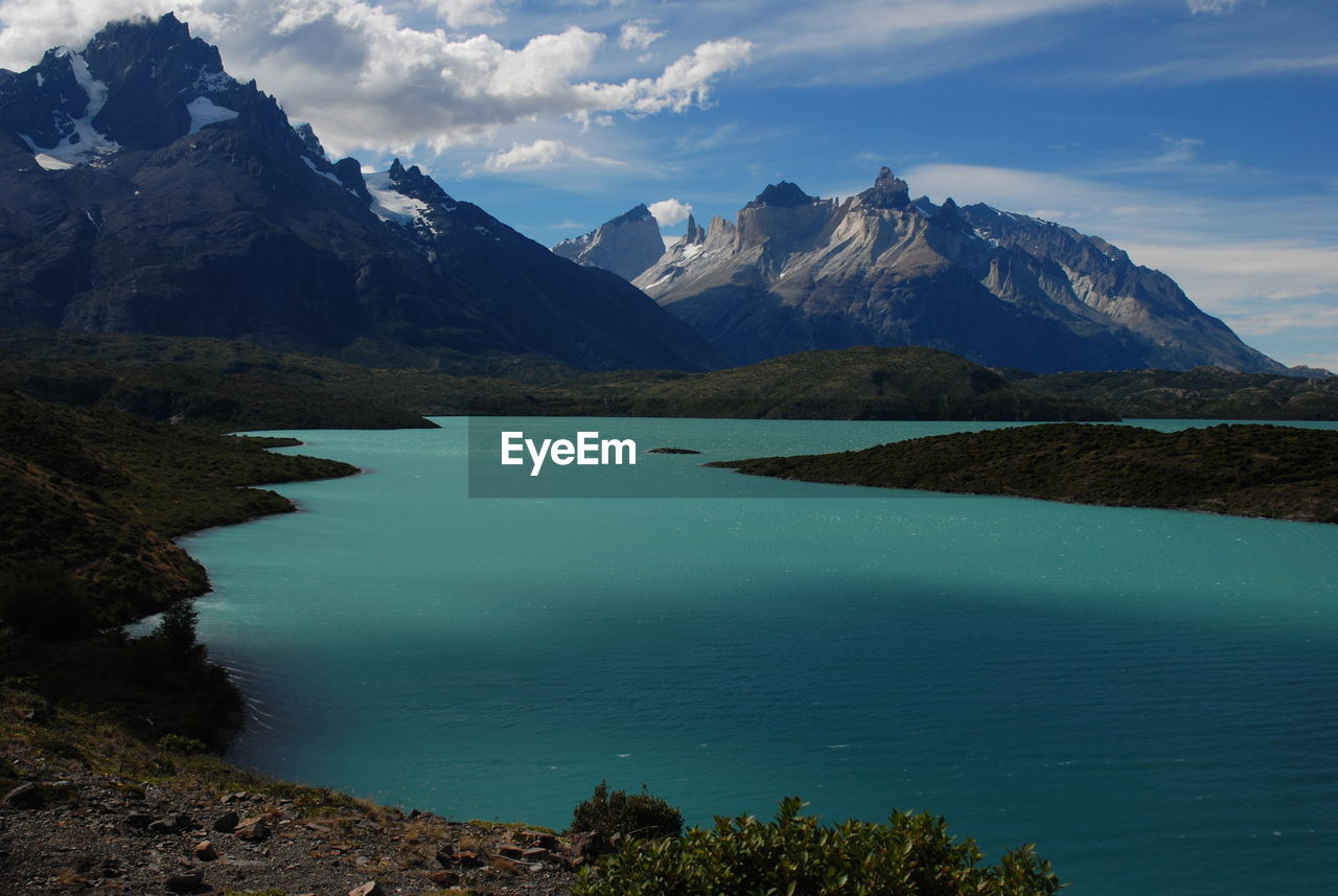 Scenic view of sea and mountains against sky