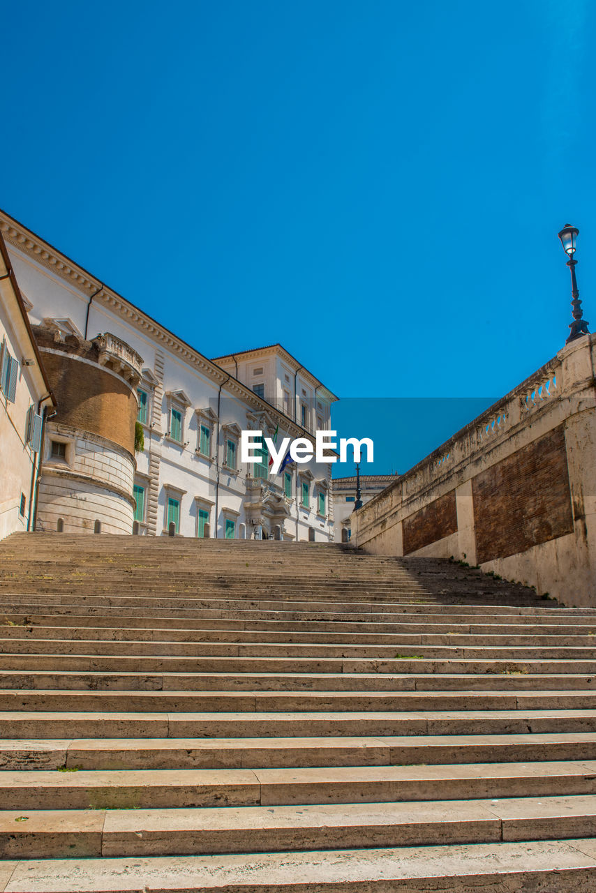 LOW ANGLE VIEW OF STEPS AGAINST CLEAR BLUE SKY