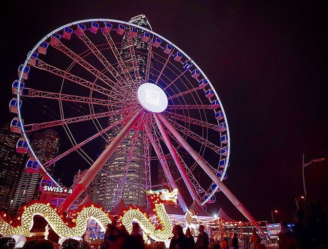 LOW ANGLE VIEW OF FERRIS WHEEL AT NIGHT