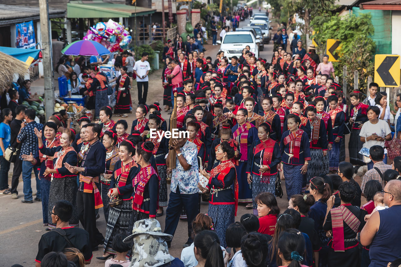 HIGH ANGLE VIEW OF PEOPLE IN STREET