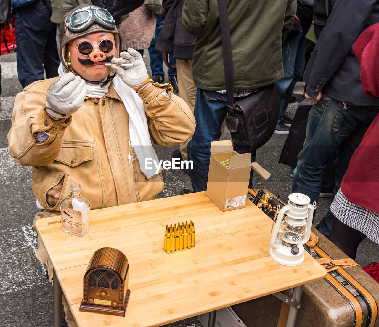 HIGH ANGLE VIEW OF PEOPLE STANDING IN FRONT OF WOODEN TABLE