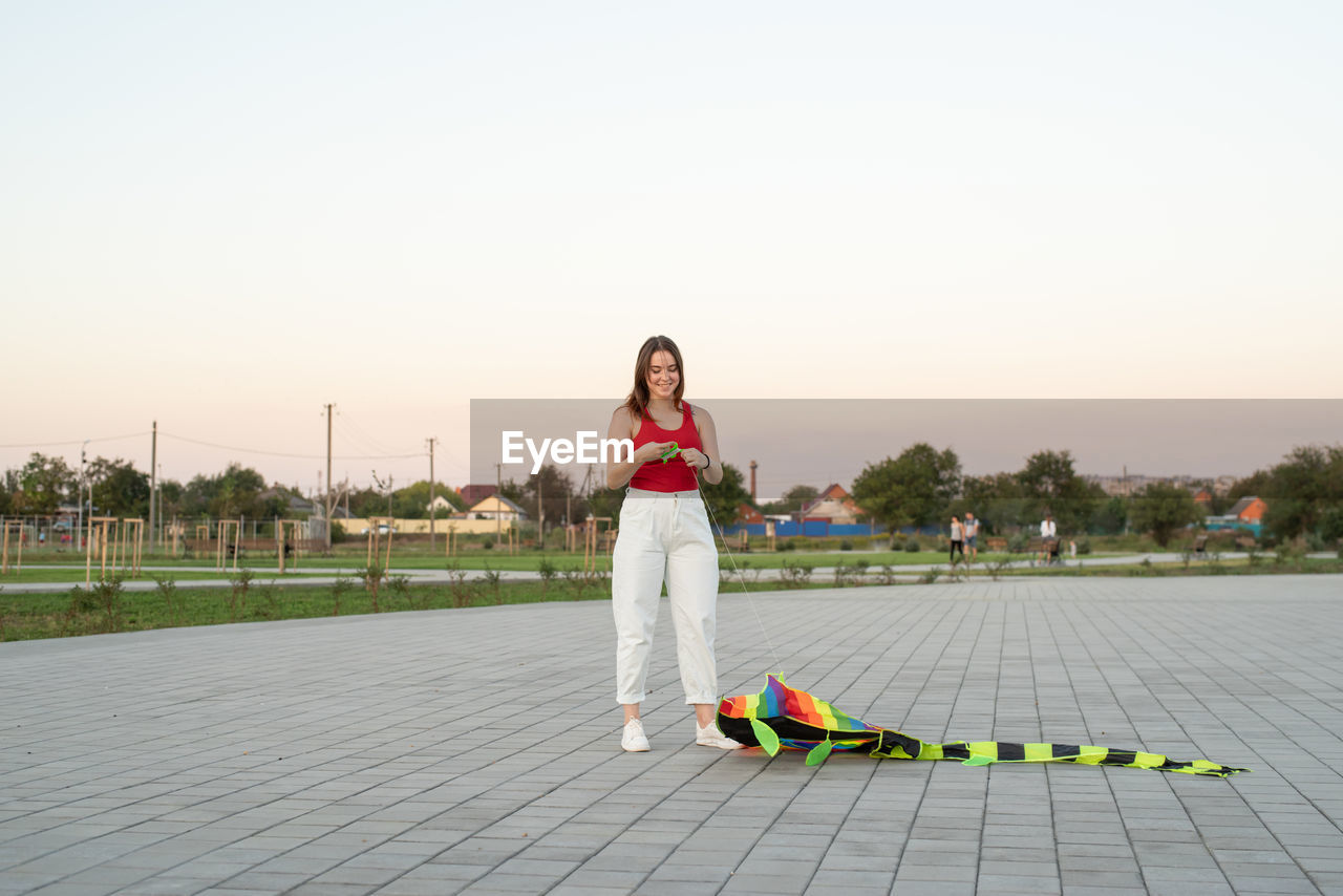 Active lifestyle. happiness concept. happy young woman running with a kite in a park at sunset