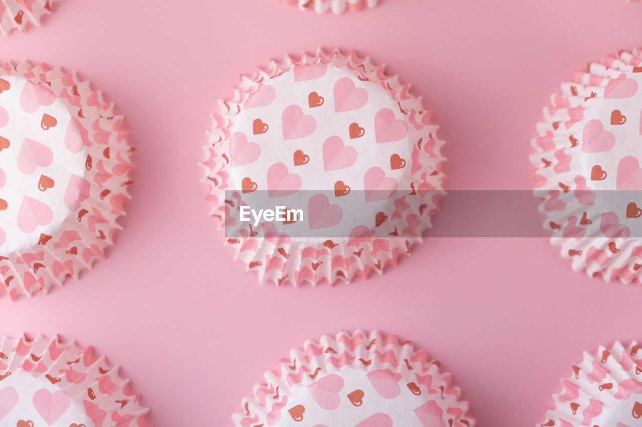 Empty pink cupcake mold with hearts on a pink background. valentine's day