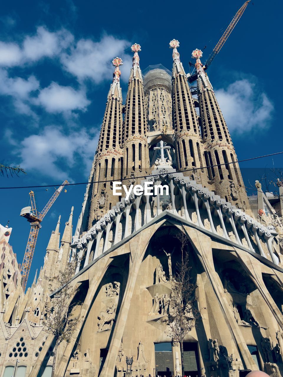 architecture, built structure, landmark, sky, building exterior, travel destinations, travel, low angle view, cloud, city, religion, the past, history, nature, building, place of worship, tourism, worship, spire, belief, tower, blue, cityscape, day, spirituality, outdoors, no people, skyscraper, gothic style, catholicism, metropolis