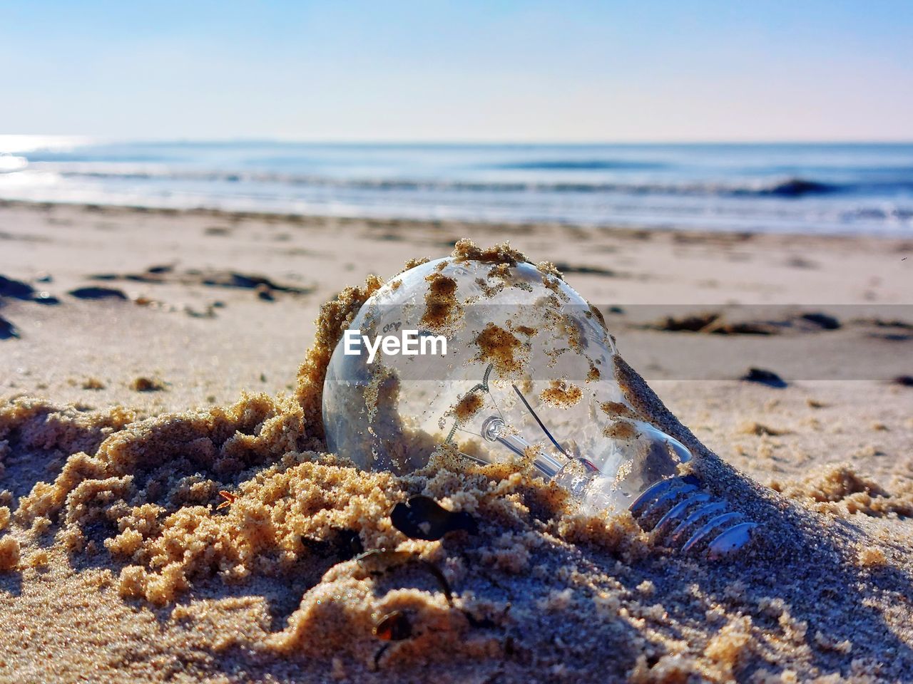 land, beach, sea, water, sand, nature, shore, sky, rock, ocean, coast, horizon over water, horizon, tranquility, no people, beauty in nature, day, wave, scenics - nature, body of water, tranquil scene, shell, sunlight, outdoors, focus on foreground, motion, clear sky, sports, close-up, natural environment, sunny, travel destinations