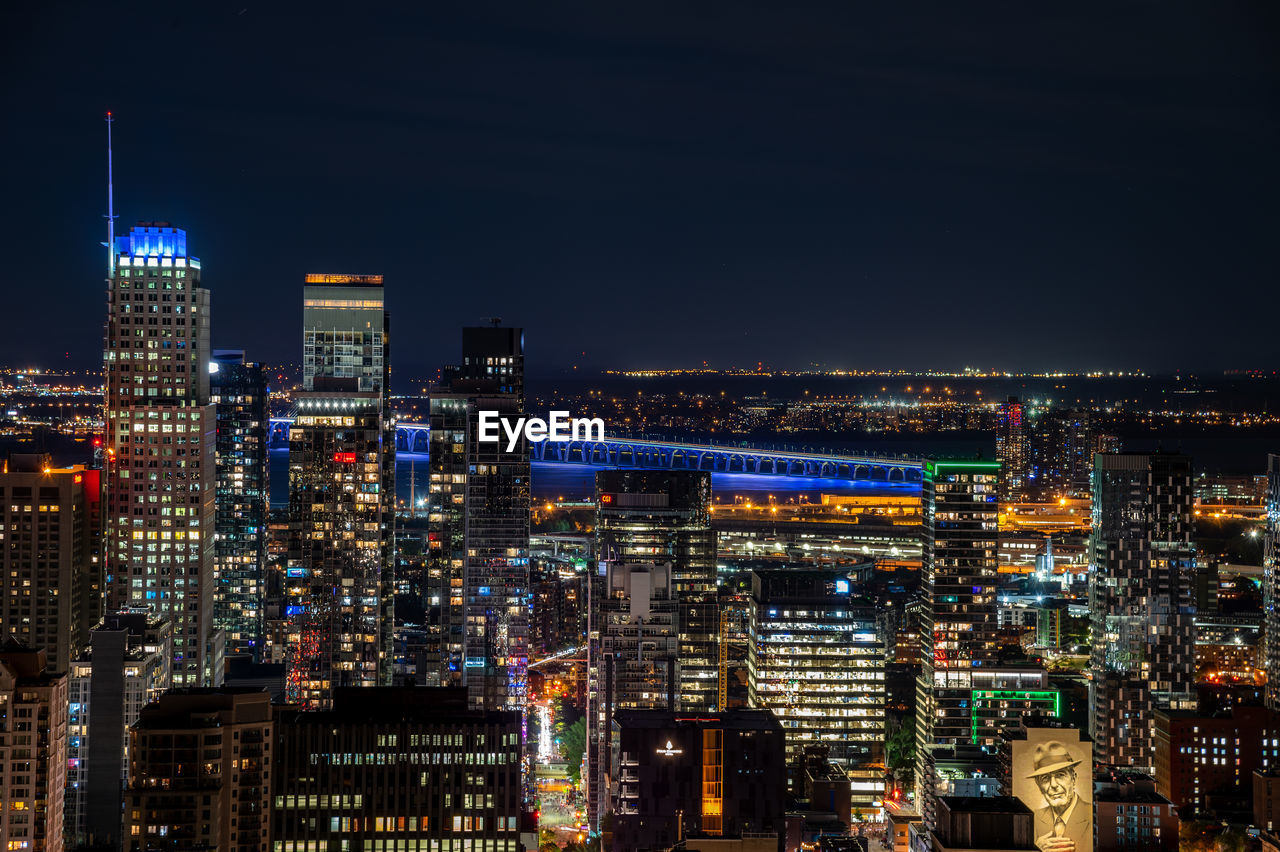 Illuminated cityscape against sky at night