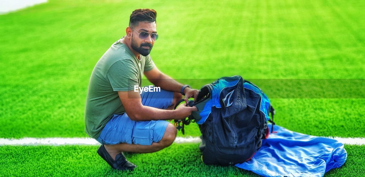 Young man sitting on field