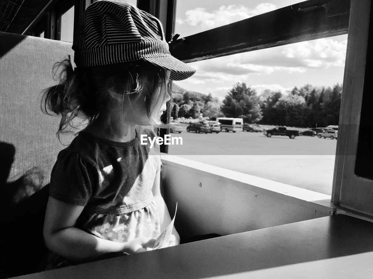 Girl looking through window