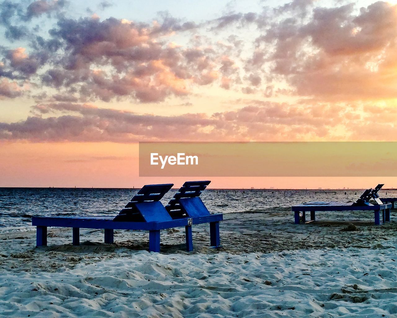 SCENIC VIEW OF BEACH AT SUNSET