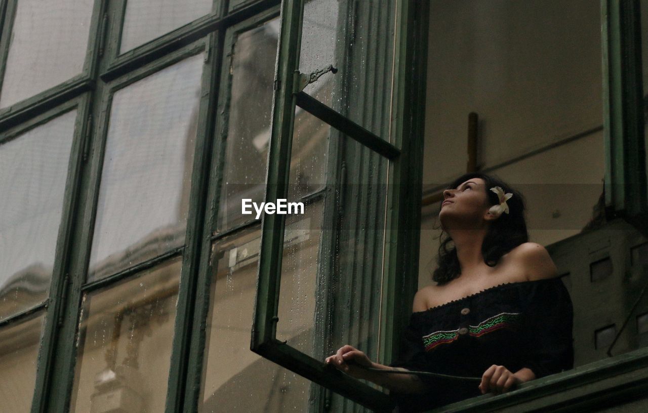 Woman looking through window