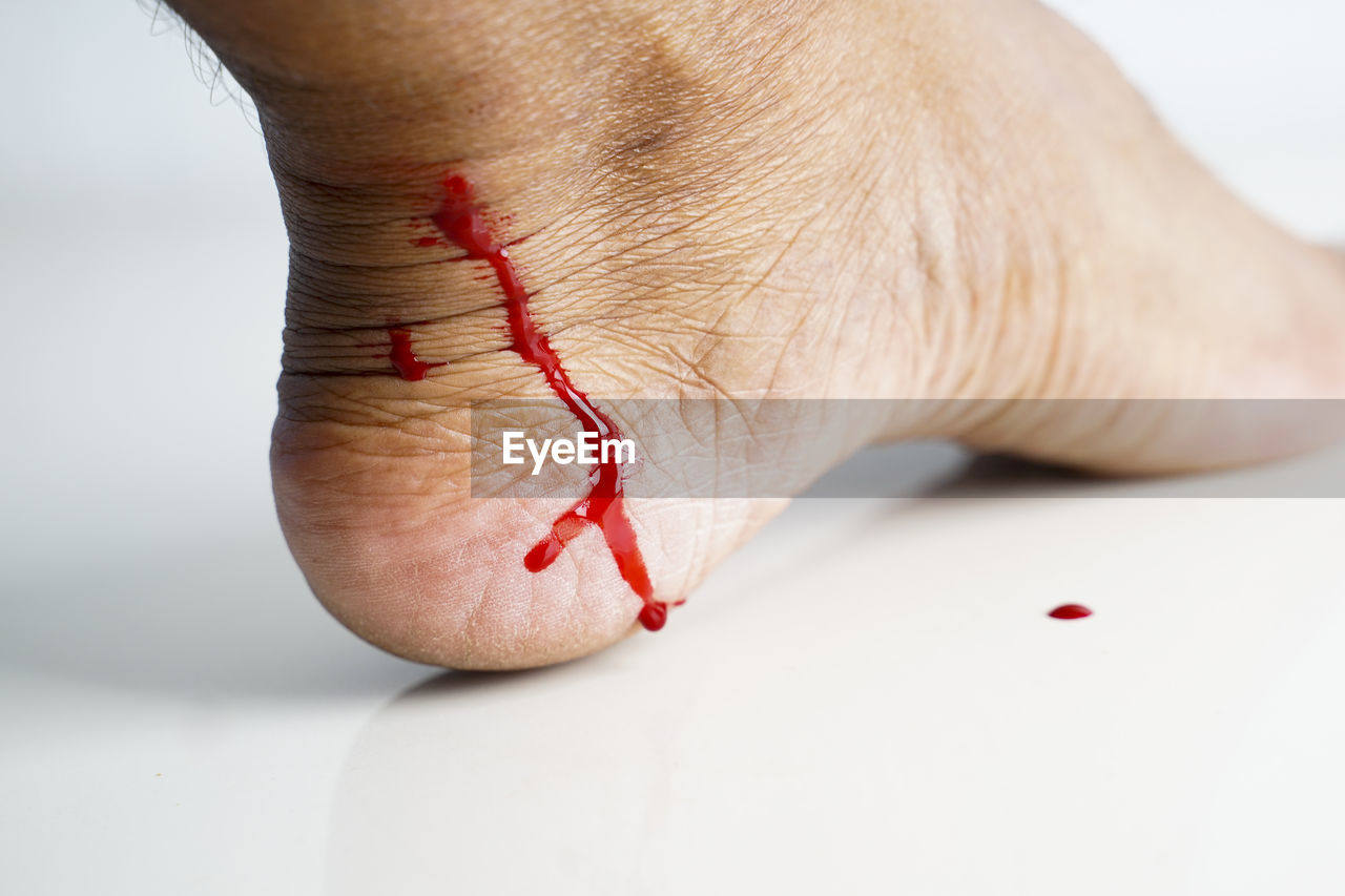 CLOSE-UP OF HUMAN HAND WITH RED EYE