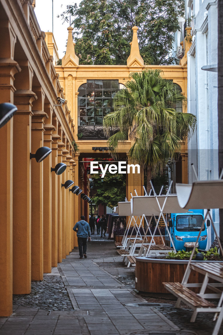 People on table by buildings in city