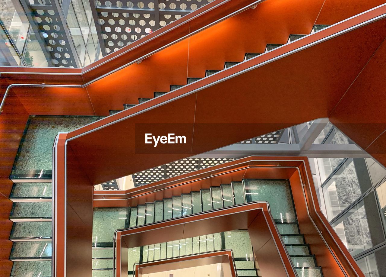 LOW ANGLE VIEW OF SPIRAL STAIRCASE AGAINST BUILDING