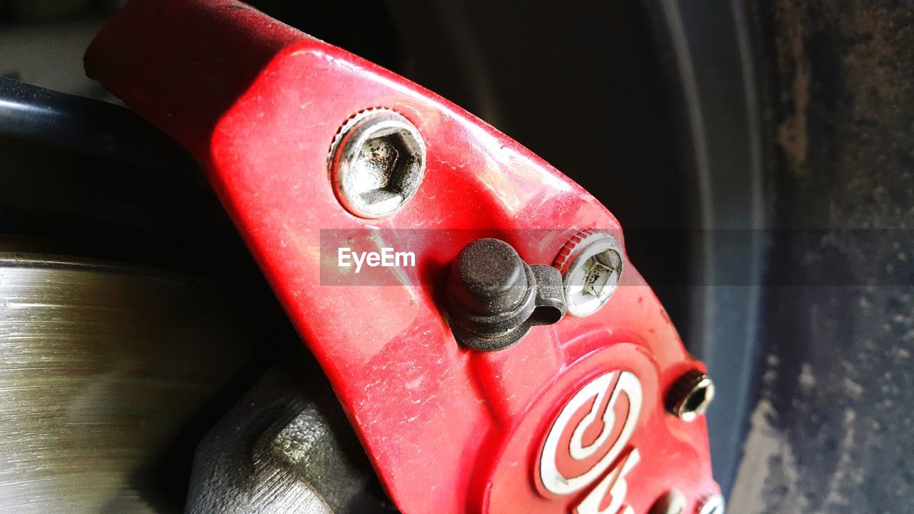 CLOSE-UP OF RED CAR ON METAL