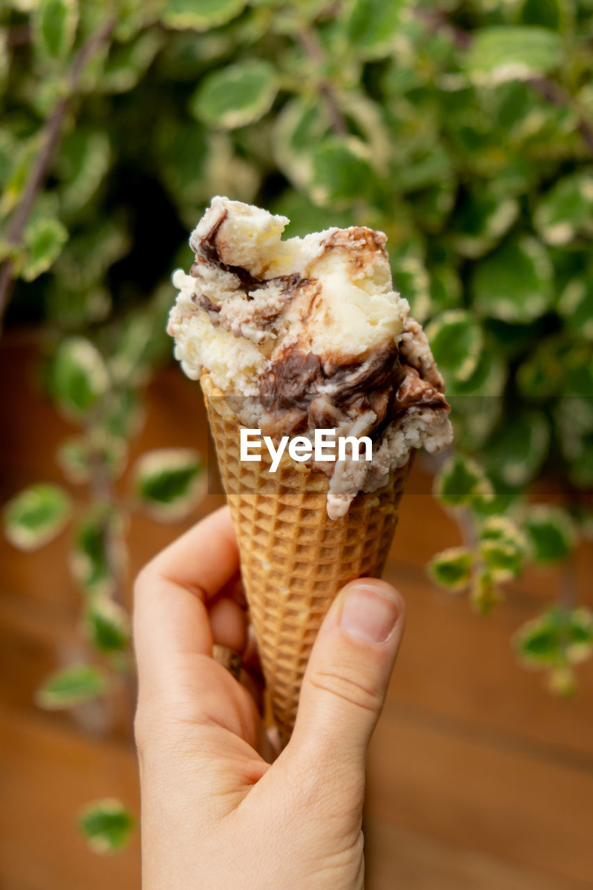 close-up of hand holding ice cream cone