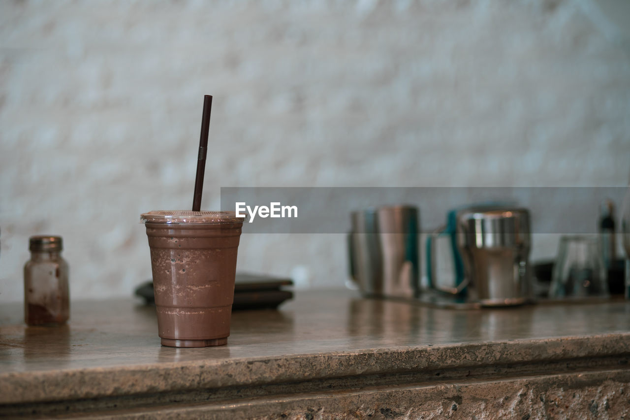 CLOSE-UP OF COFFEE CUP ON TABLE