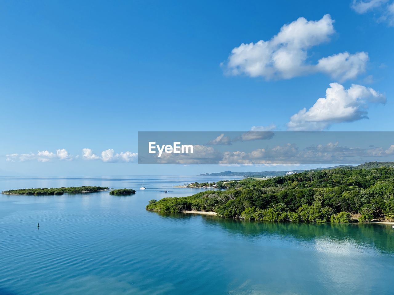 Scenic view of sea against blue sky